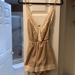 Beige romper with open back detail